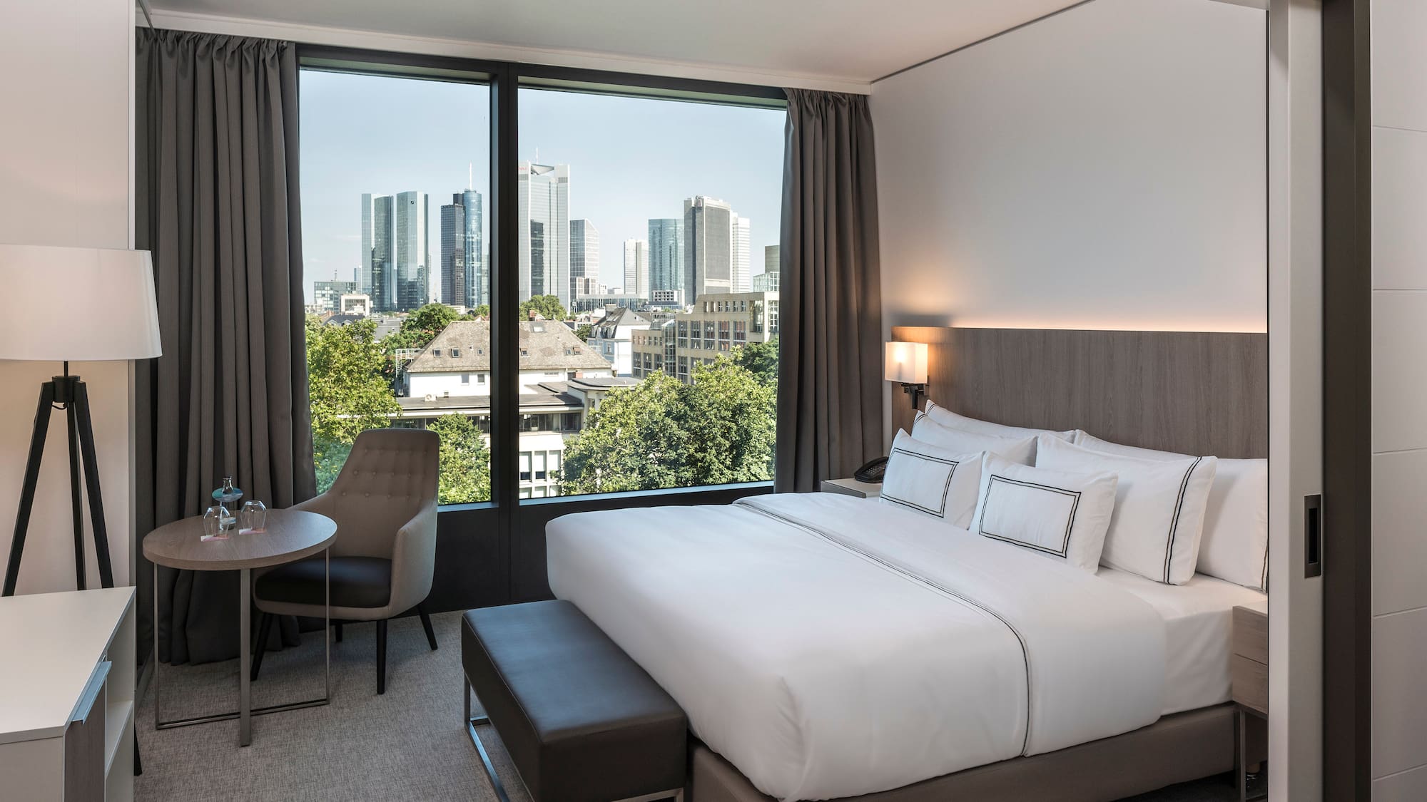 a bedroom with a bed and a table and chairs