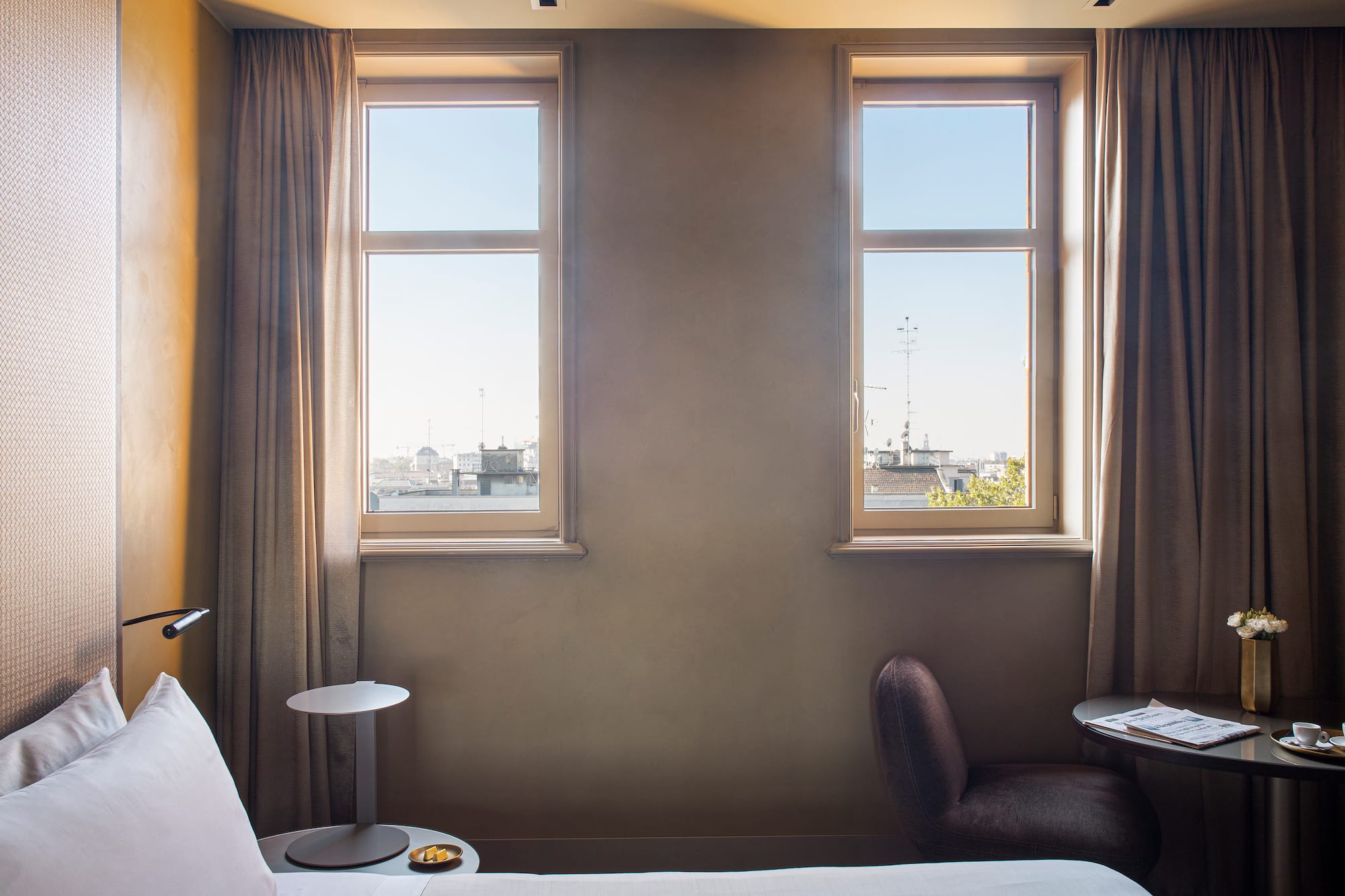 a bedroom with a bed and a table and chairs