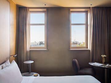 a bedroom with a bed and a table and chairs