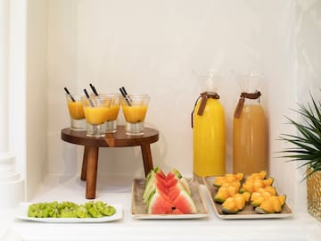 a table with fruit and juices