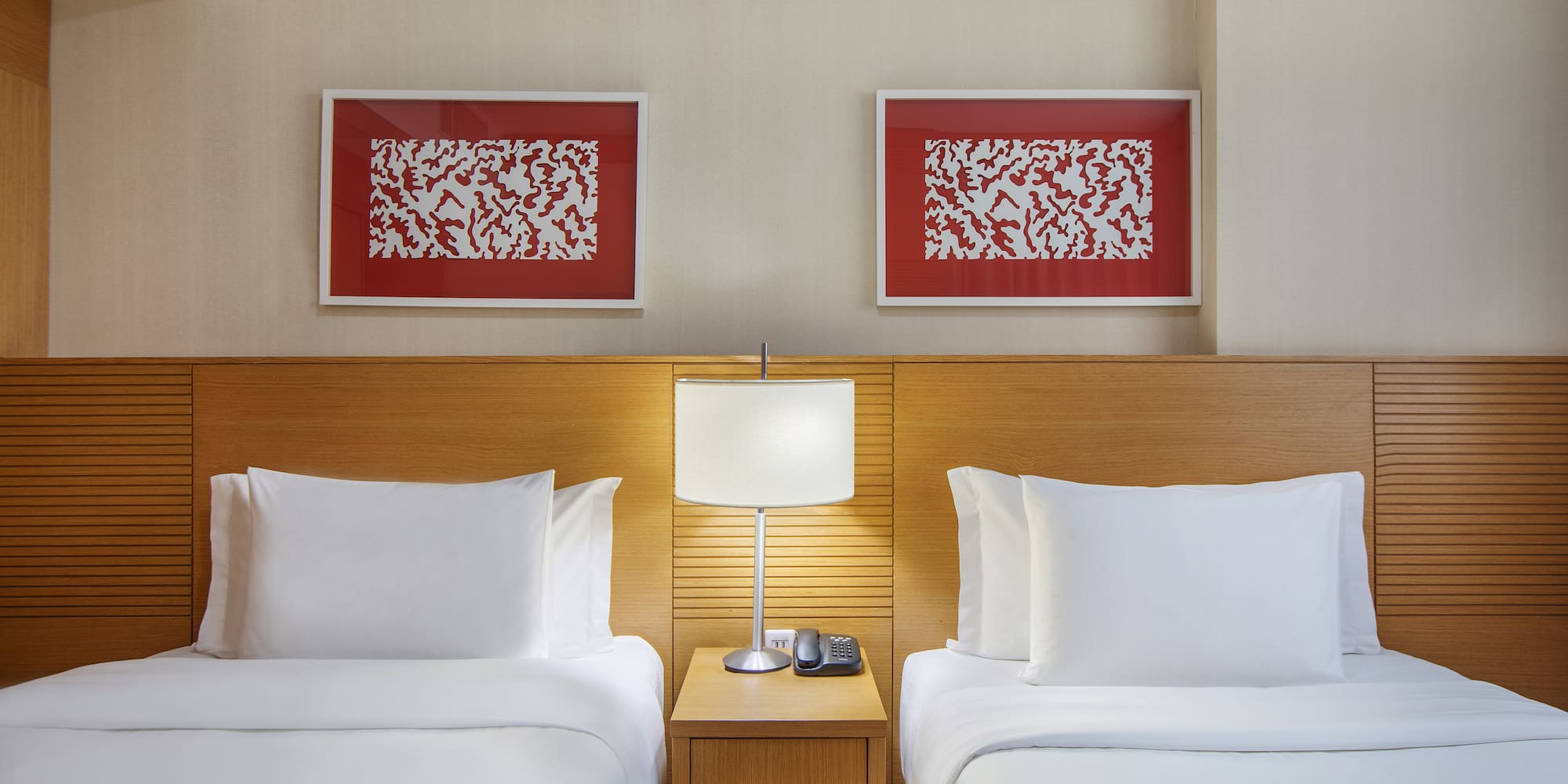 a room with two beds and a lamp