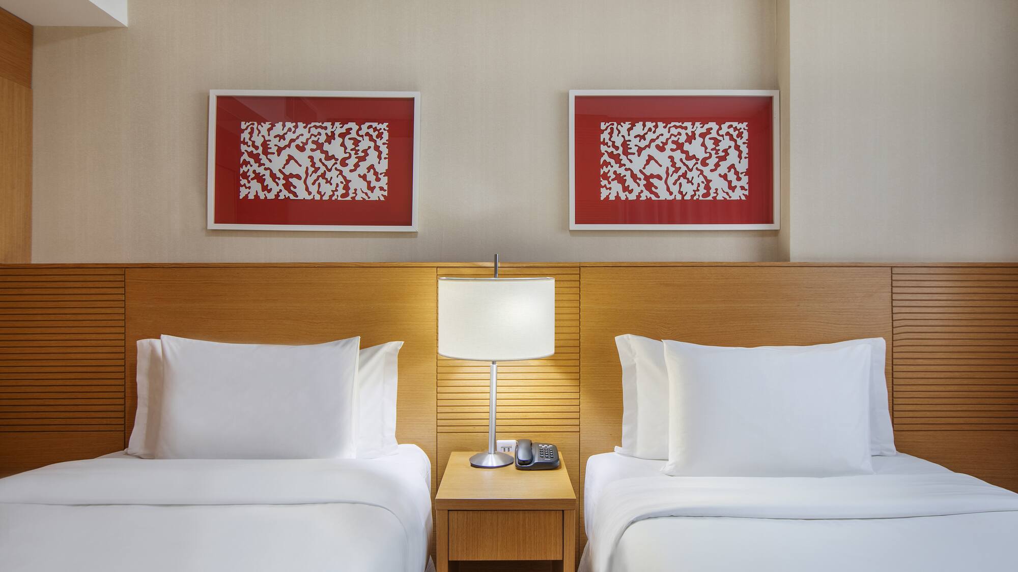 a room with two beds and a lamp