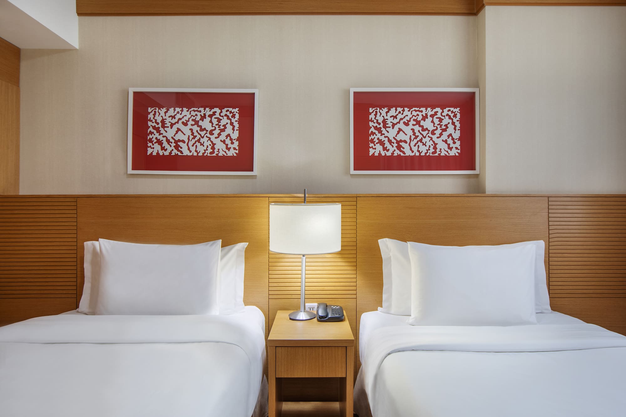 a room with two beds and a lamp