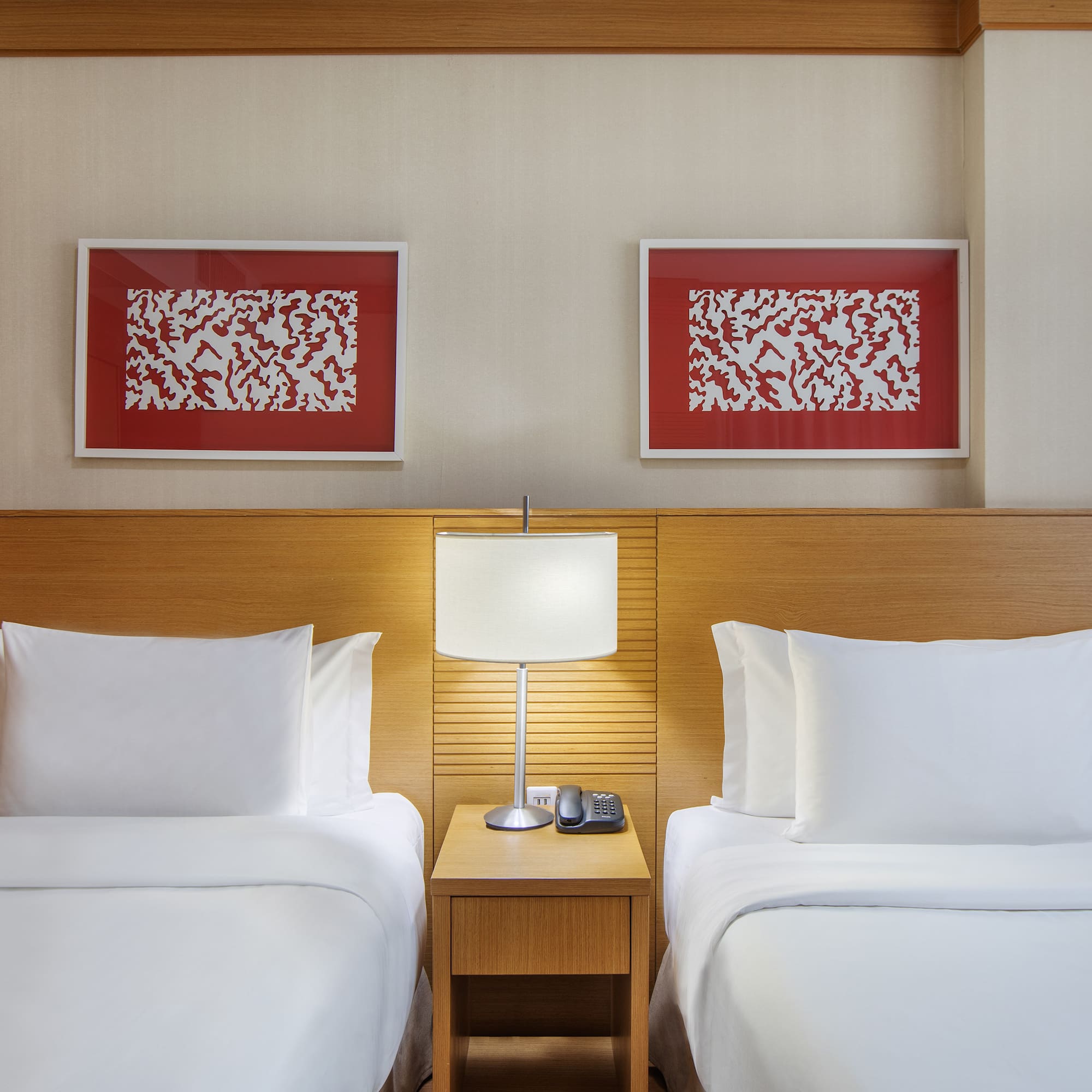 a room with two beds and a lamp