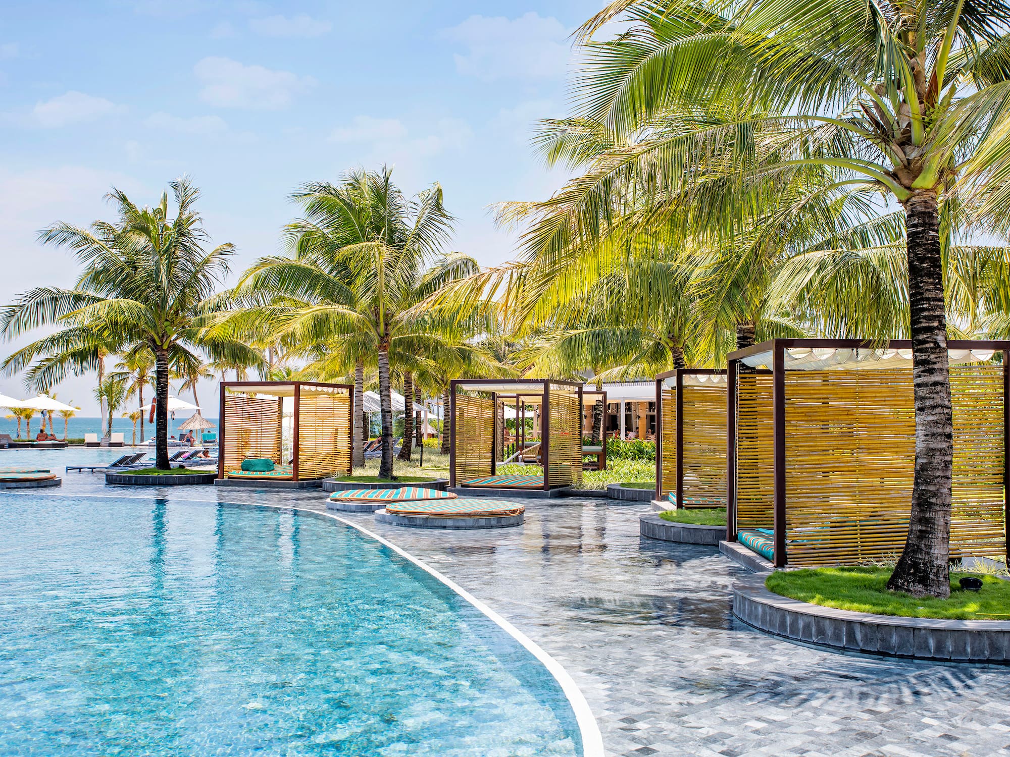 a pool with palm trees and a gazebo