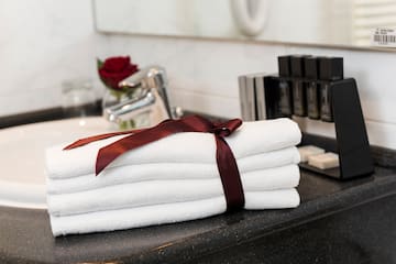 a stack of towels with a bow on a counter top