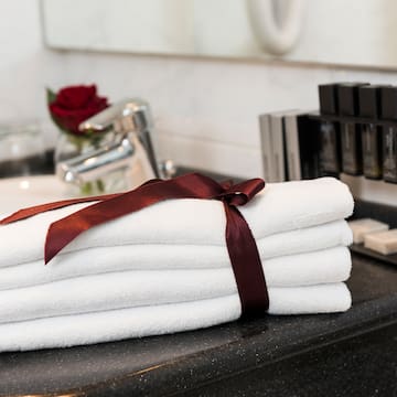 a stack of towels with a bow on a counter top