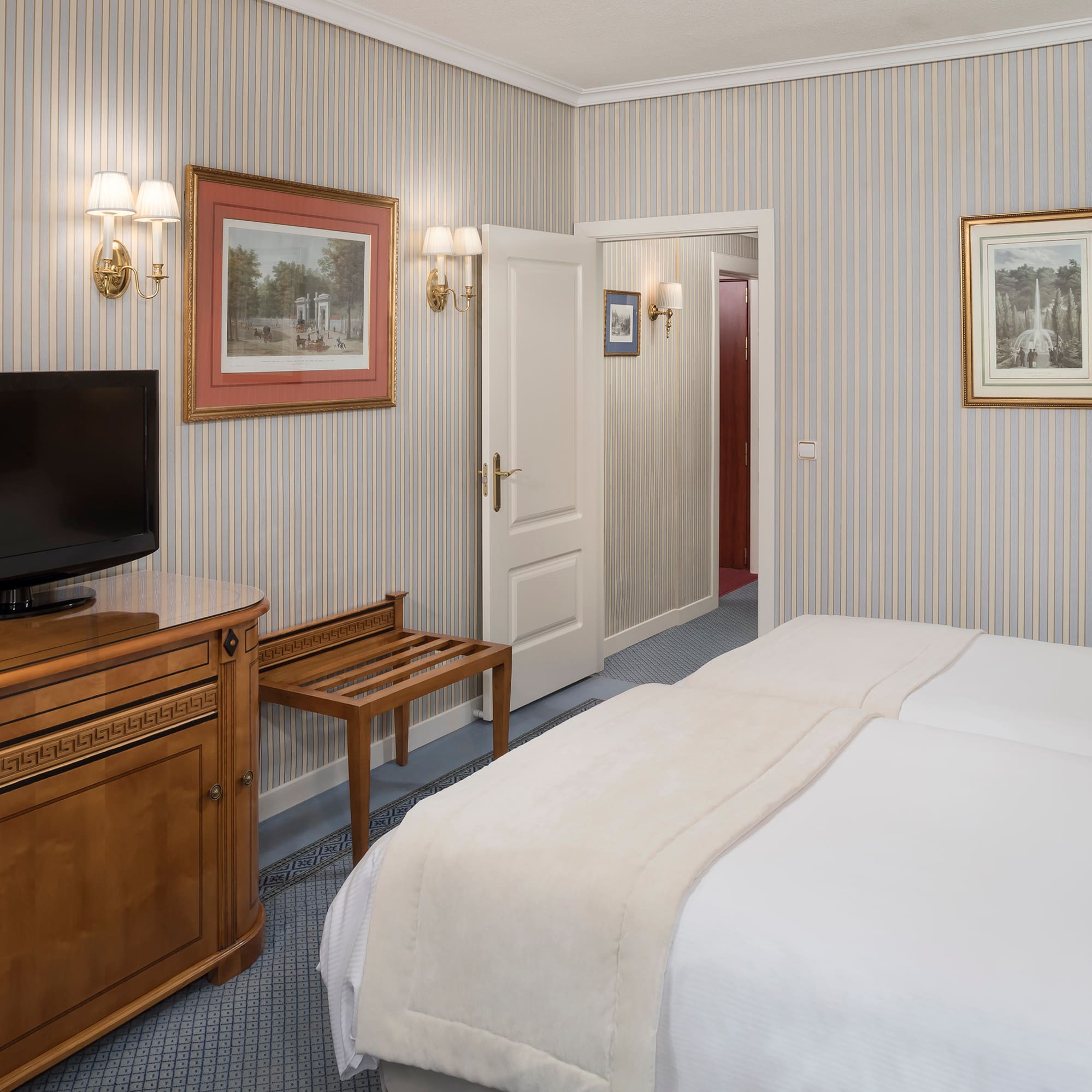 a room with a bed and a television