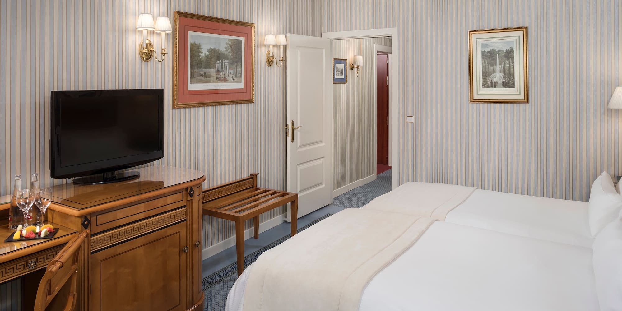 a room with a bed and a television