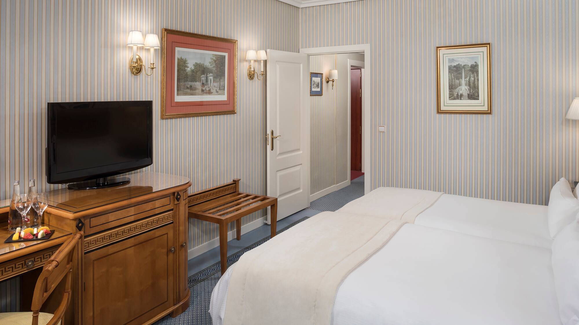 a room with a bed and a television