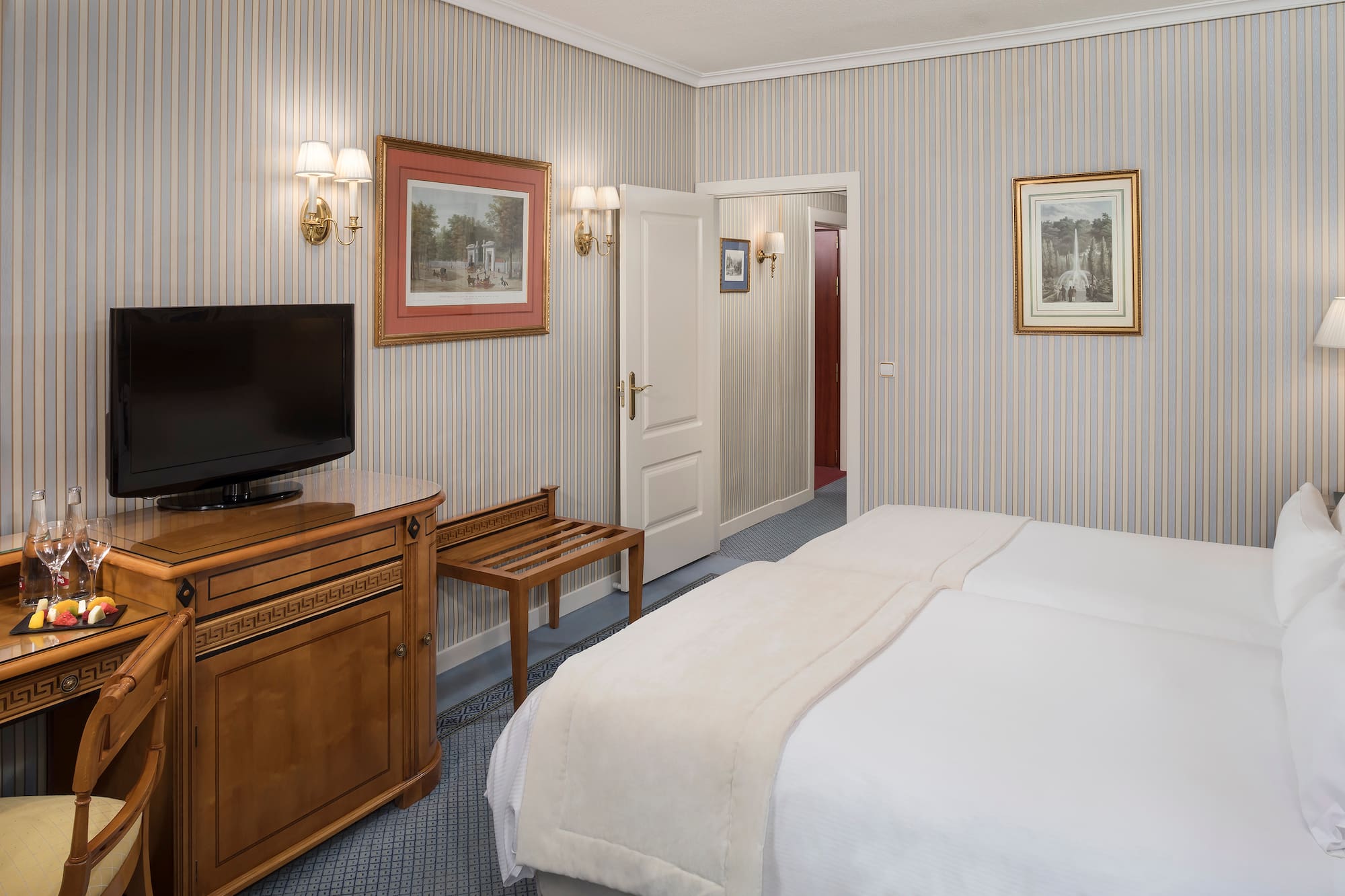 a room with a bed and a television