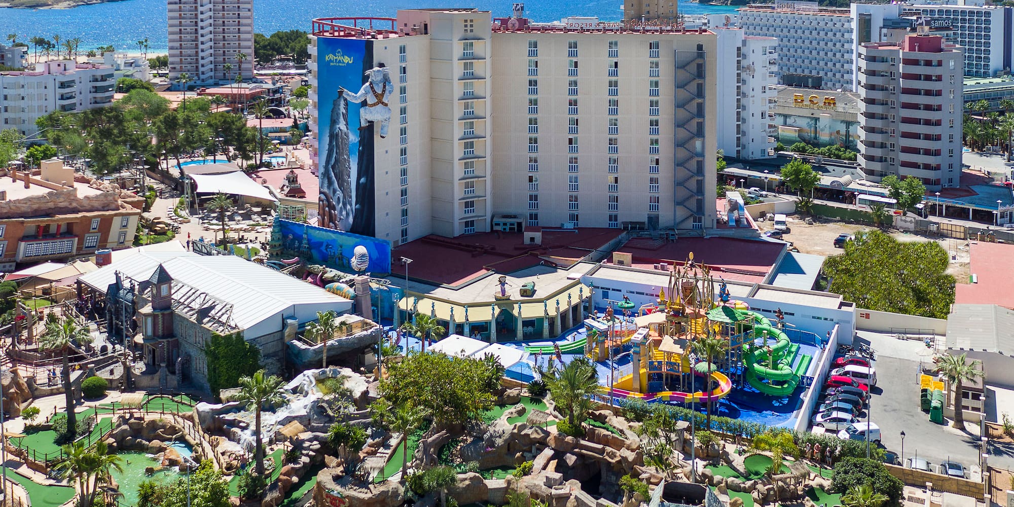 a resort with a playground and a body of water