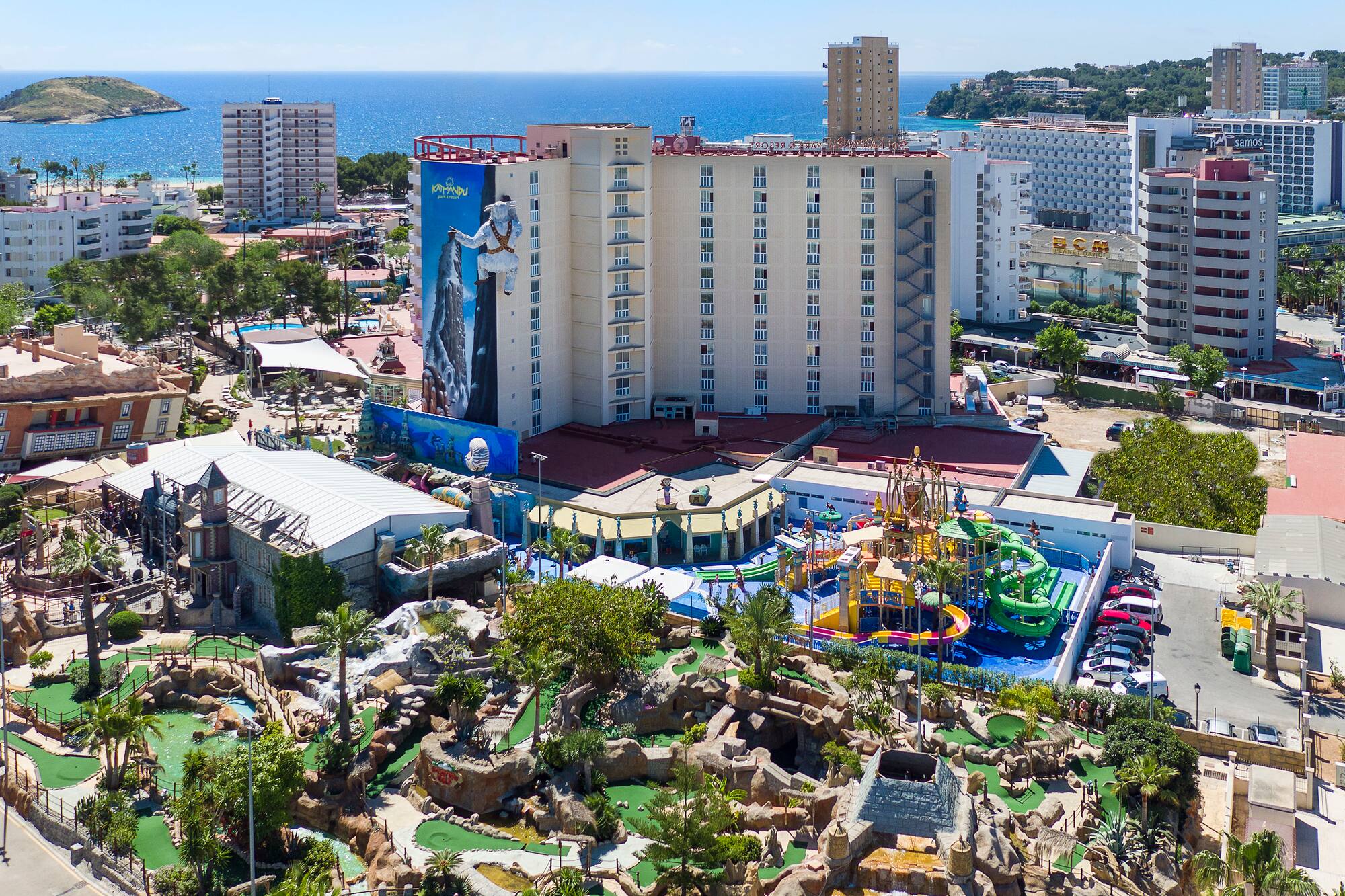 a resort with a playground and a body of water