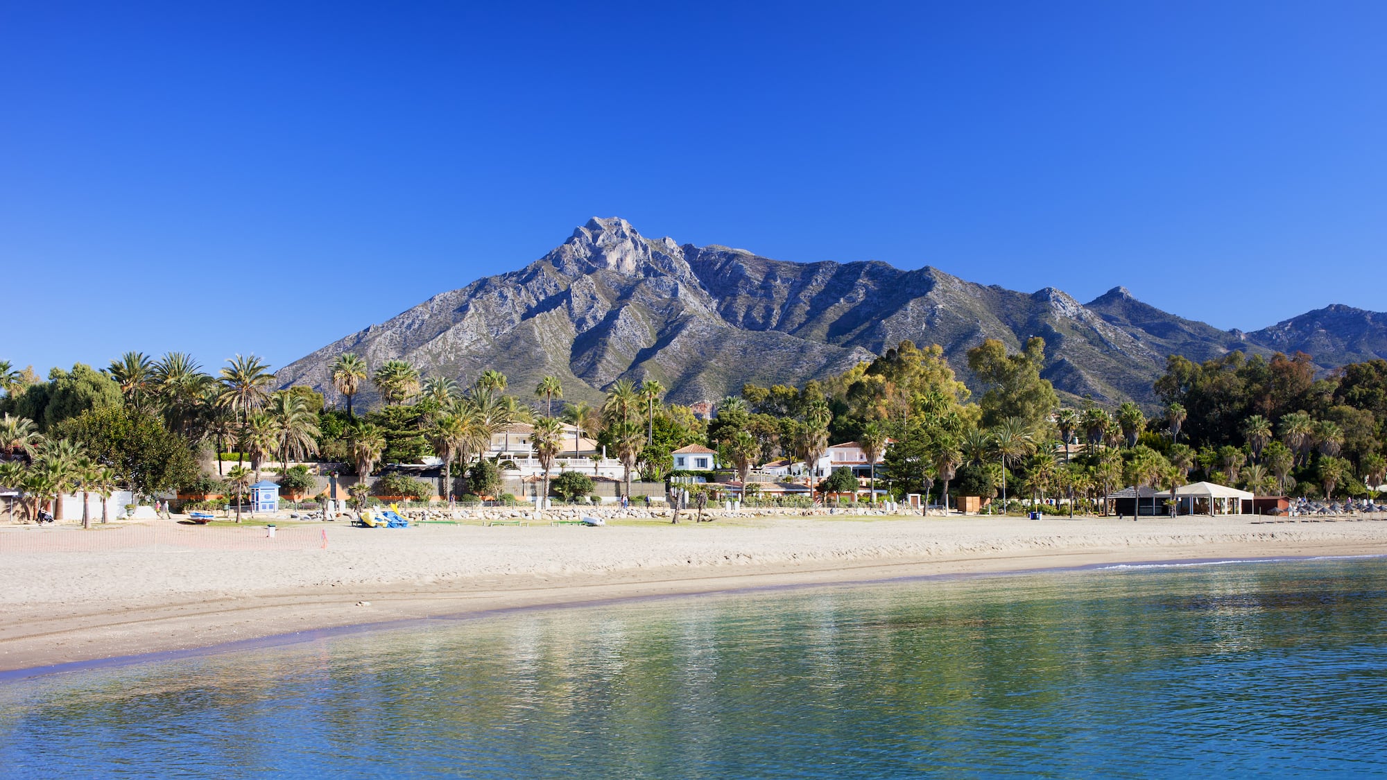 a beach with a mountain in the background
