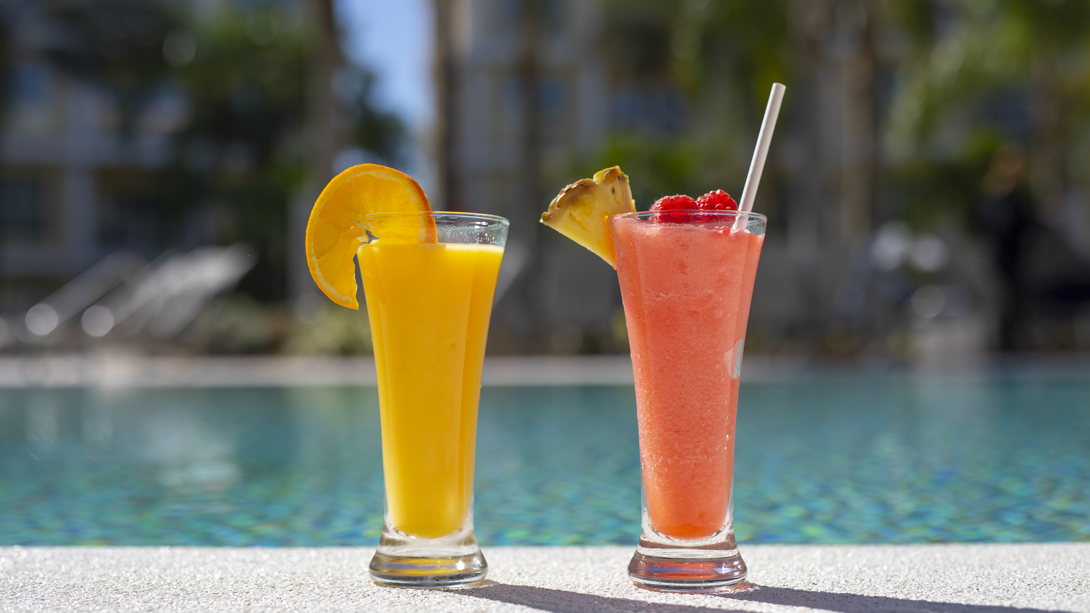 two glasses of juice next to each other