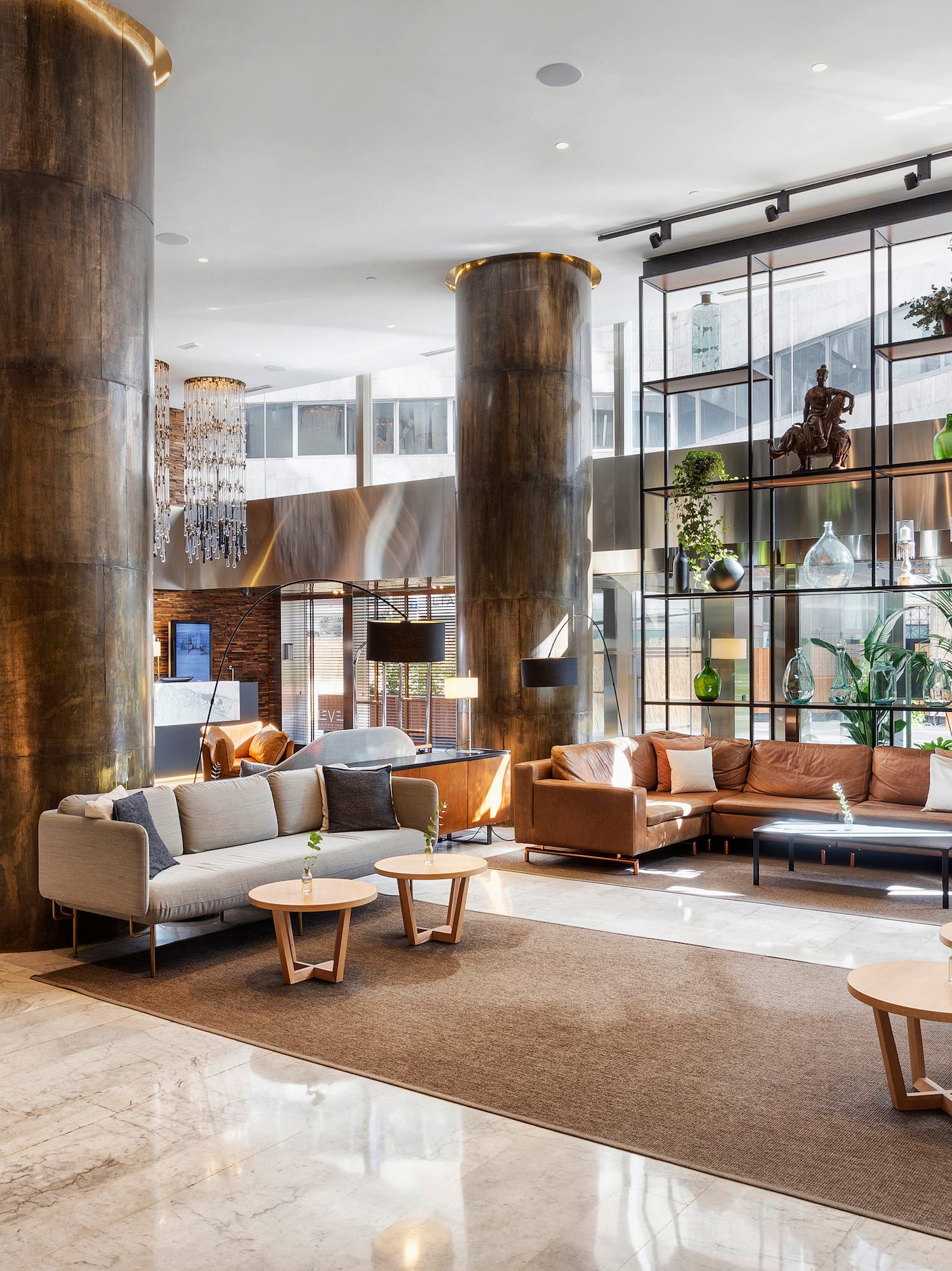 a lobby with a large column and a large couch