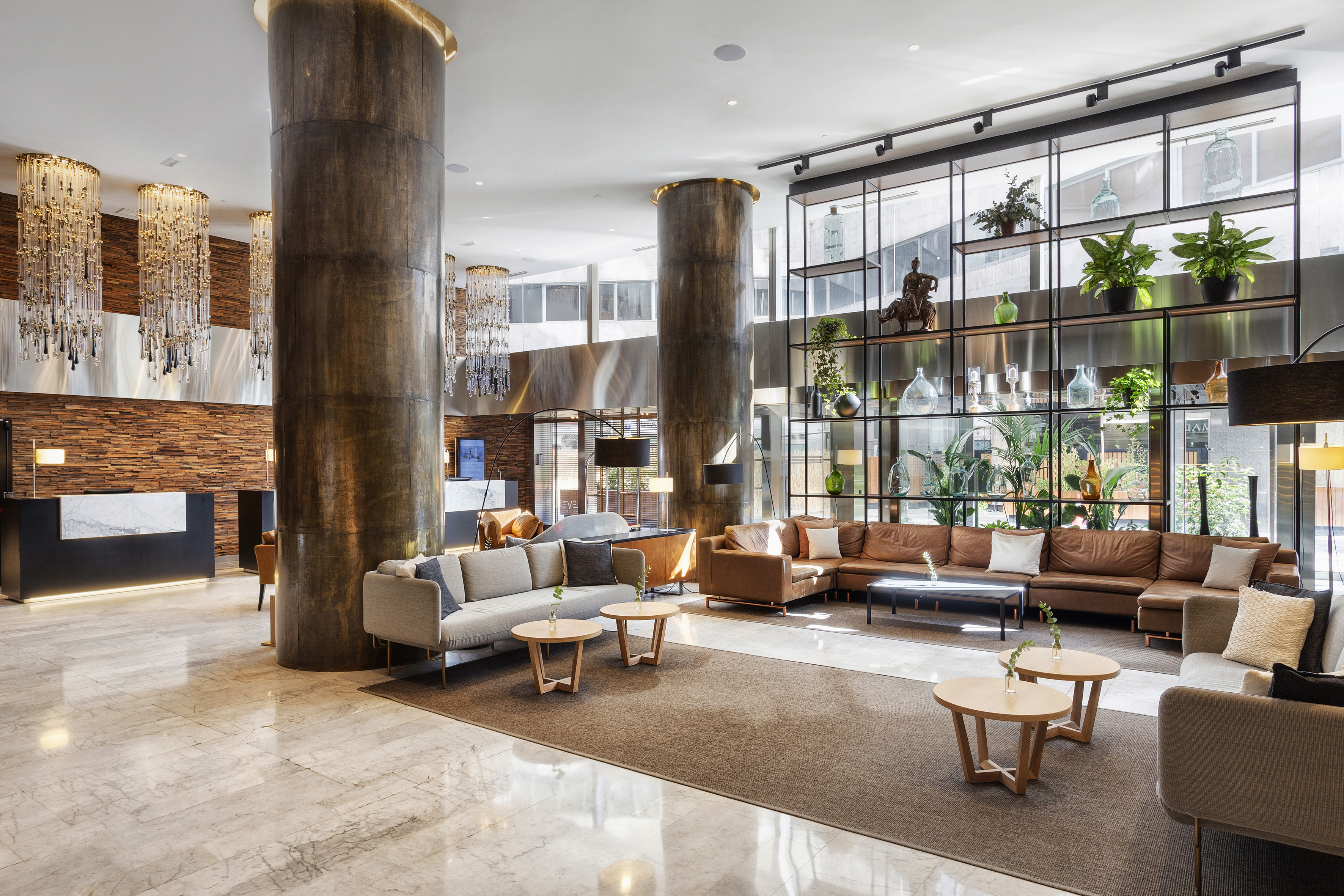a lobby with a large column and a large couch