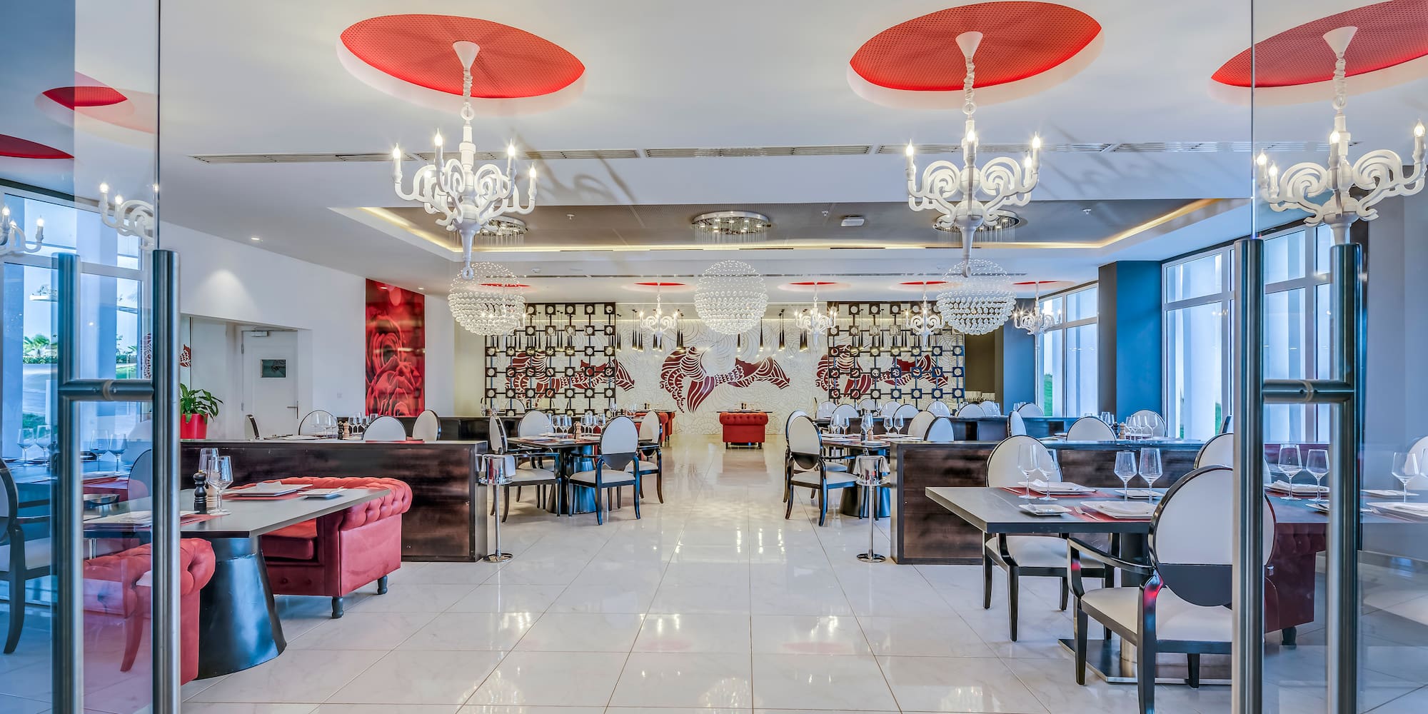 a restaurant with chandeliers and tables