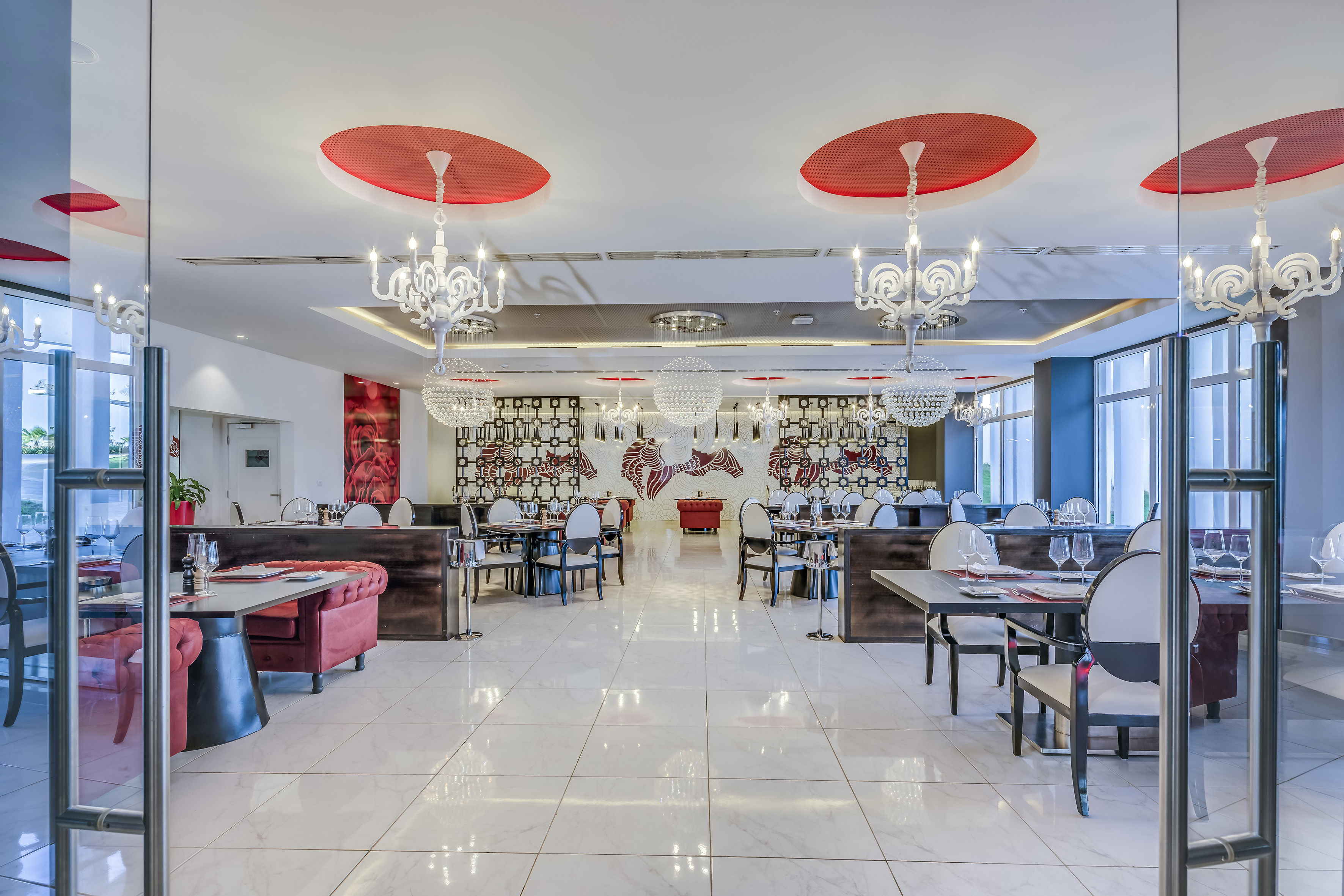 a restaurant with chandeliers and tables