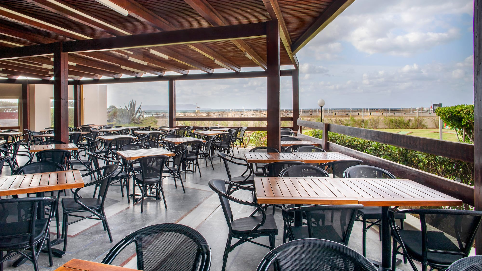 a patio with tables and chairs
