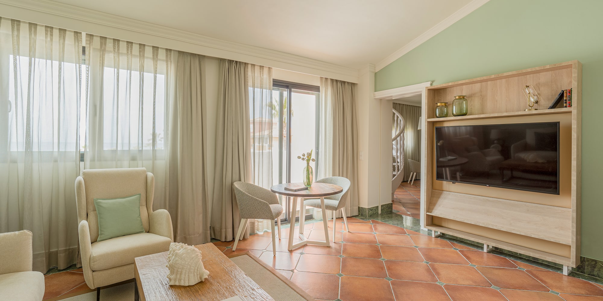 a living room with a television and a chair