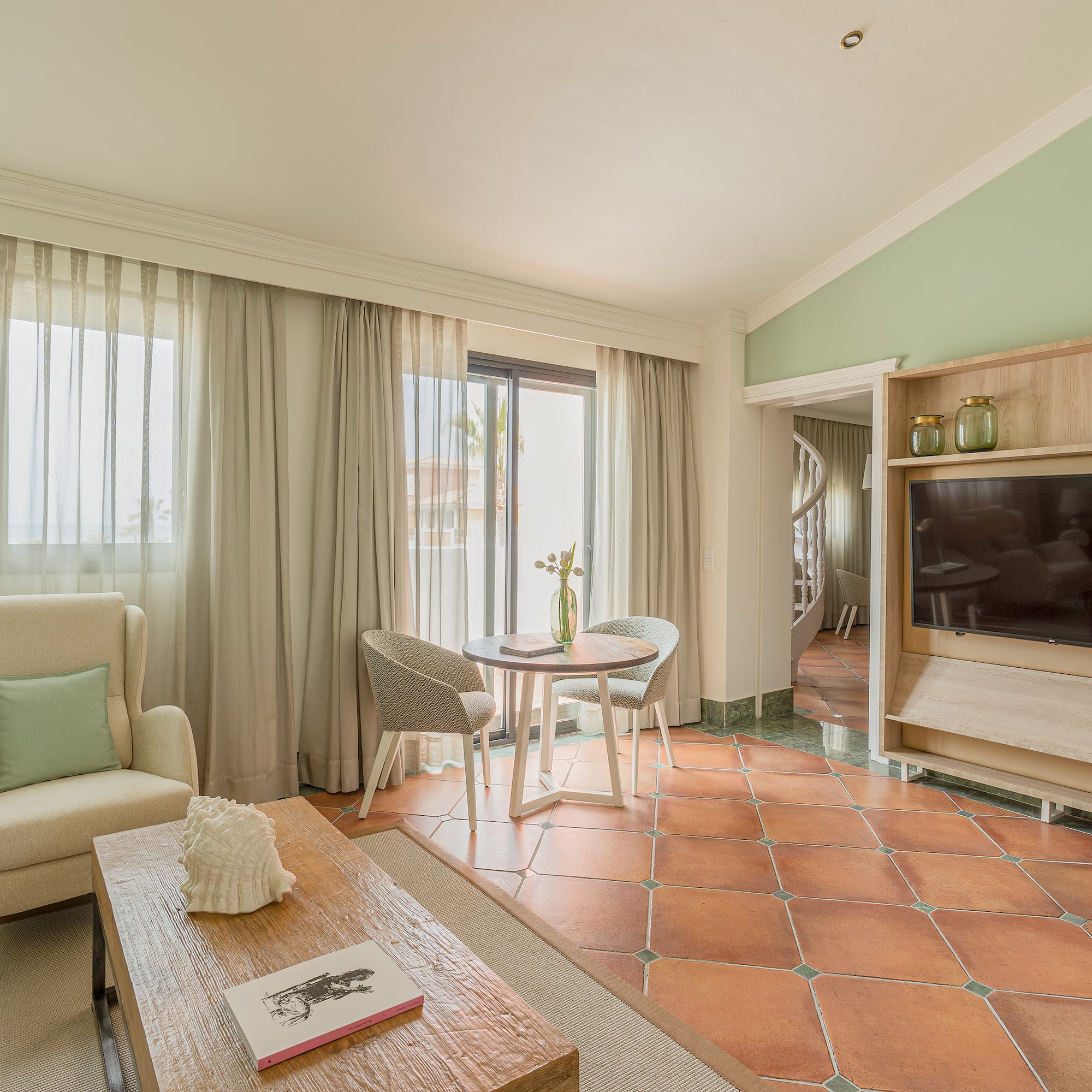 a living room with a television and a chair