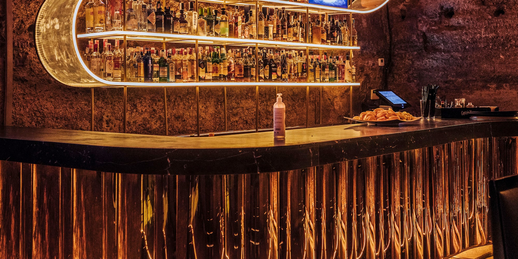 a bar with a shelf of liquor
