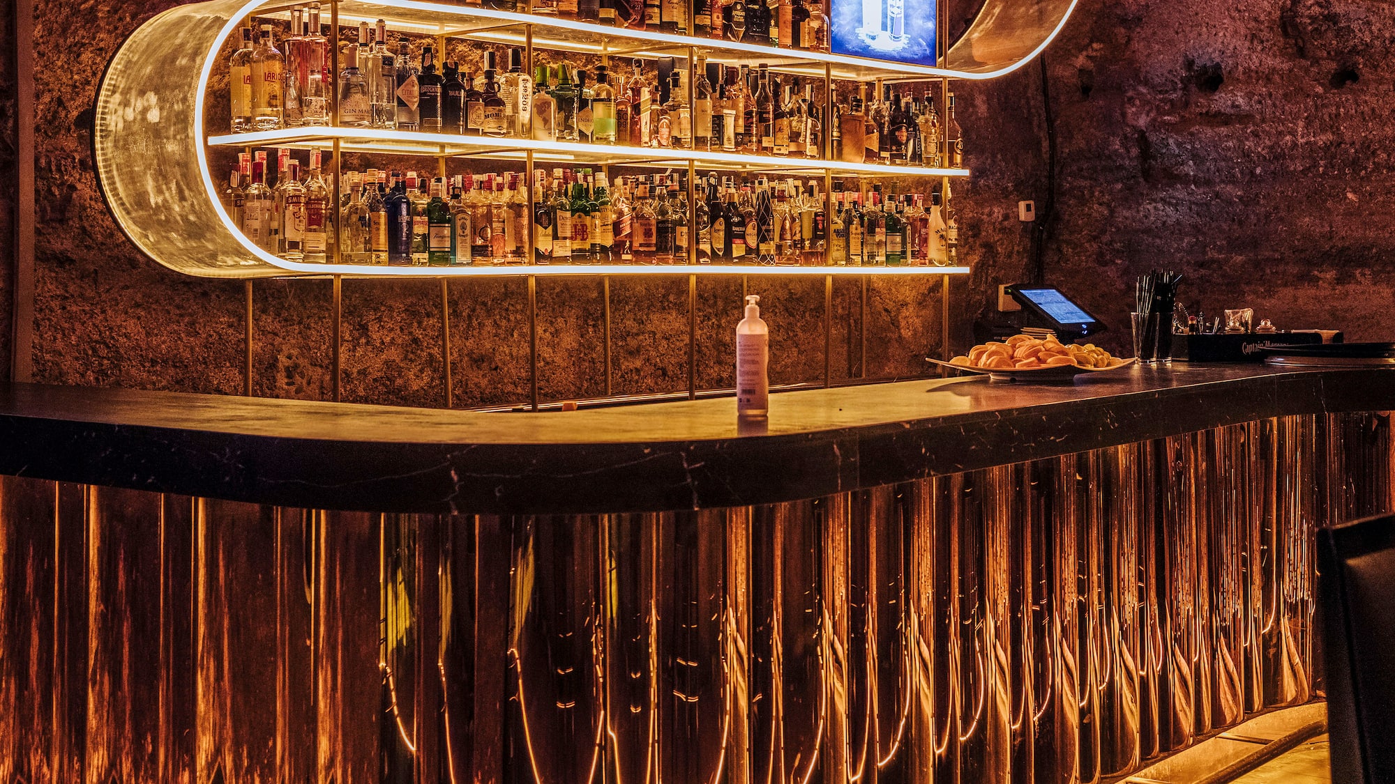 a bar with a shelf of liquor