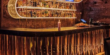 a bar with a shelf of liquor