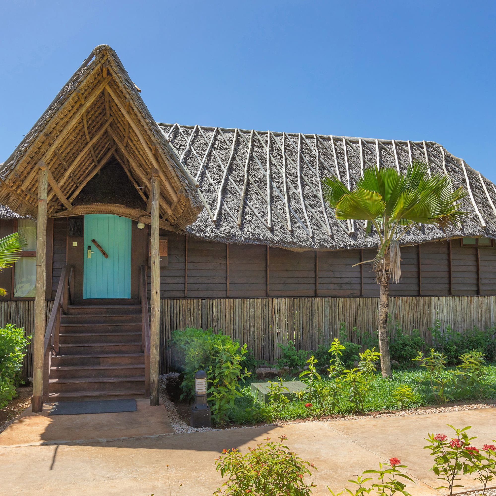 a house with a thatched roof and a blue door