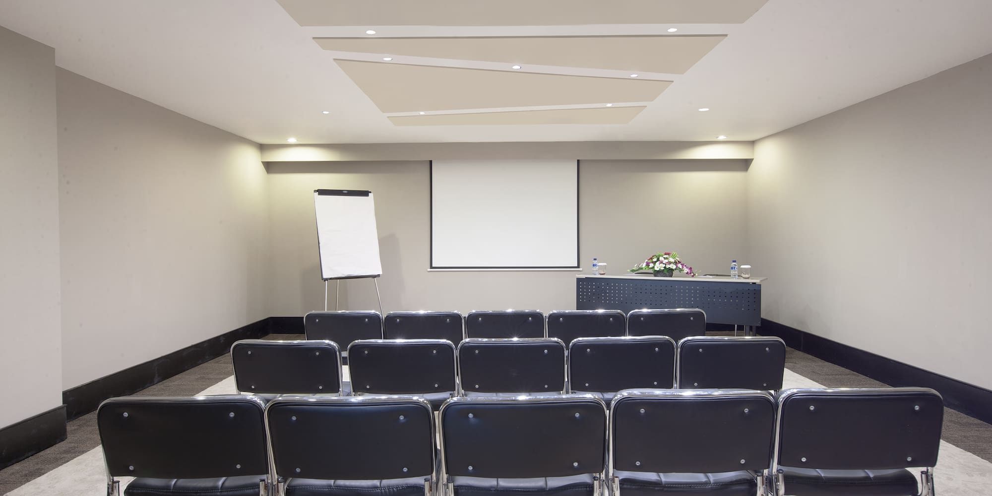 a room with chairs and a projector screen