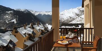 a table with food on it and a view of mountains