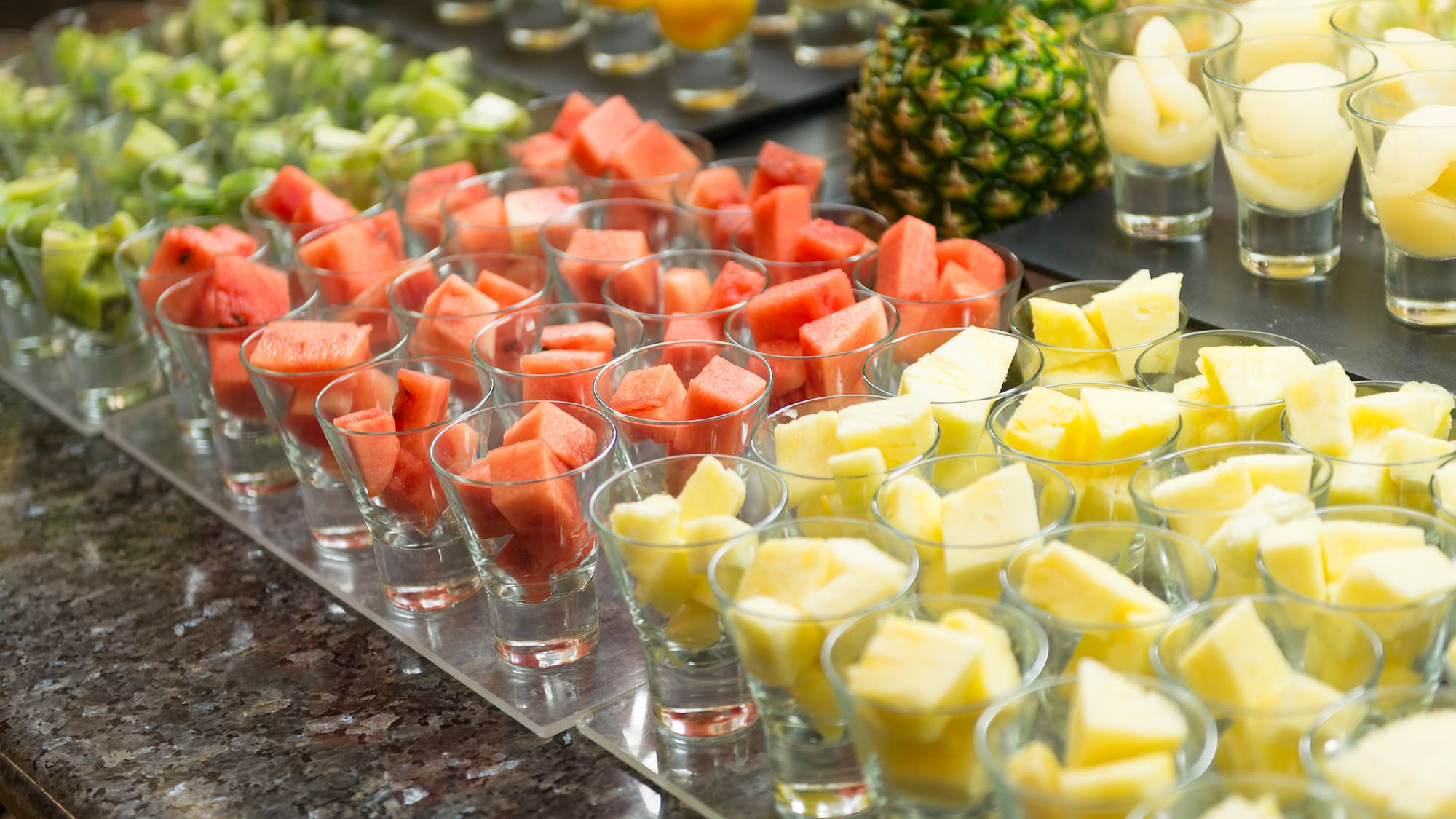 a group of glasses filled with fruit