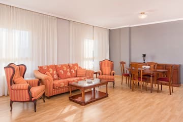 a living room with a couch and chairs