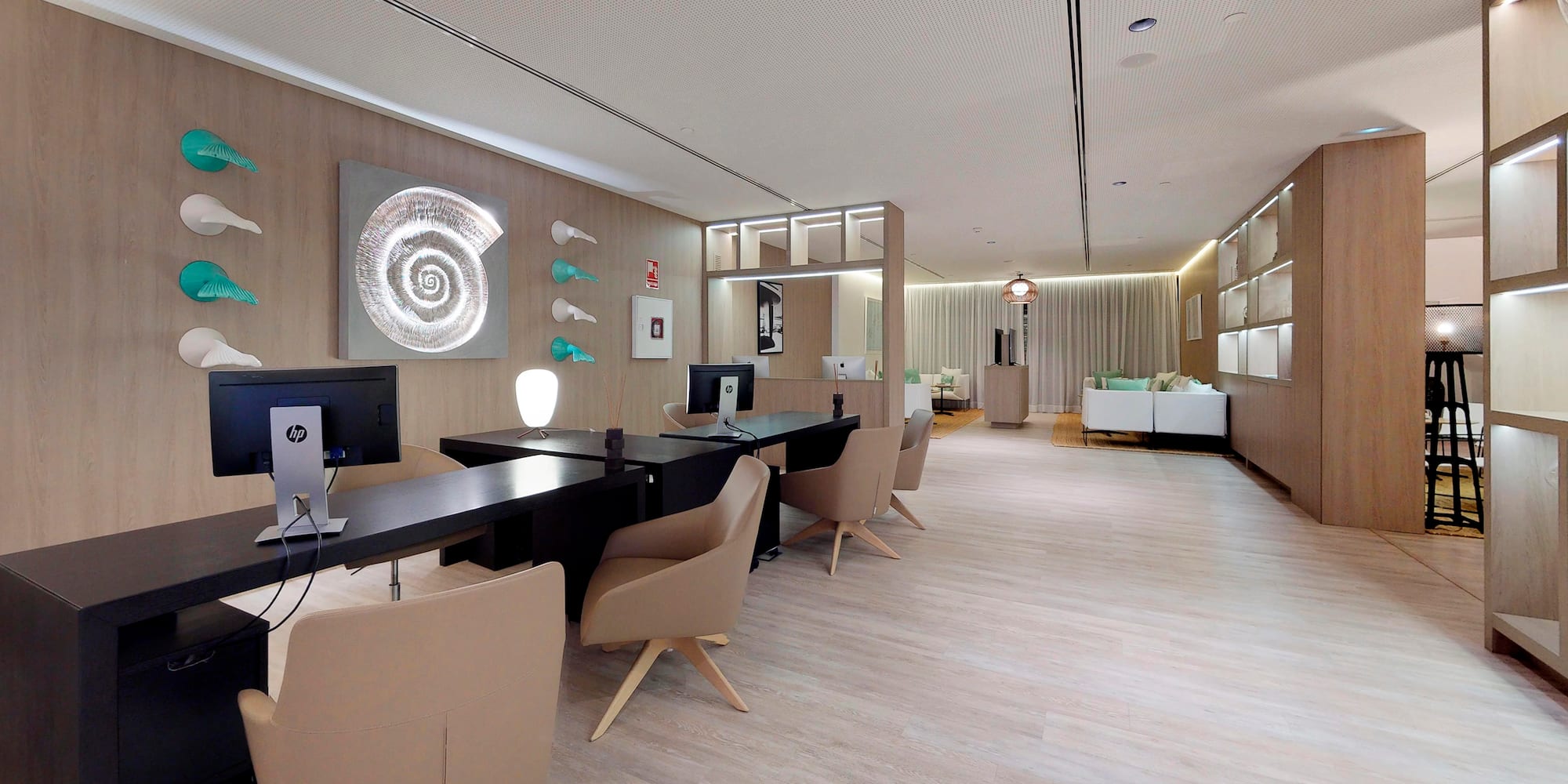 a room with a computer desk and chairs