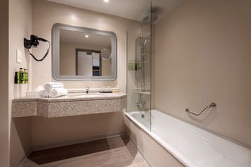 a bathroom with a bathtub and a mirror