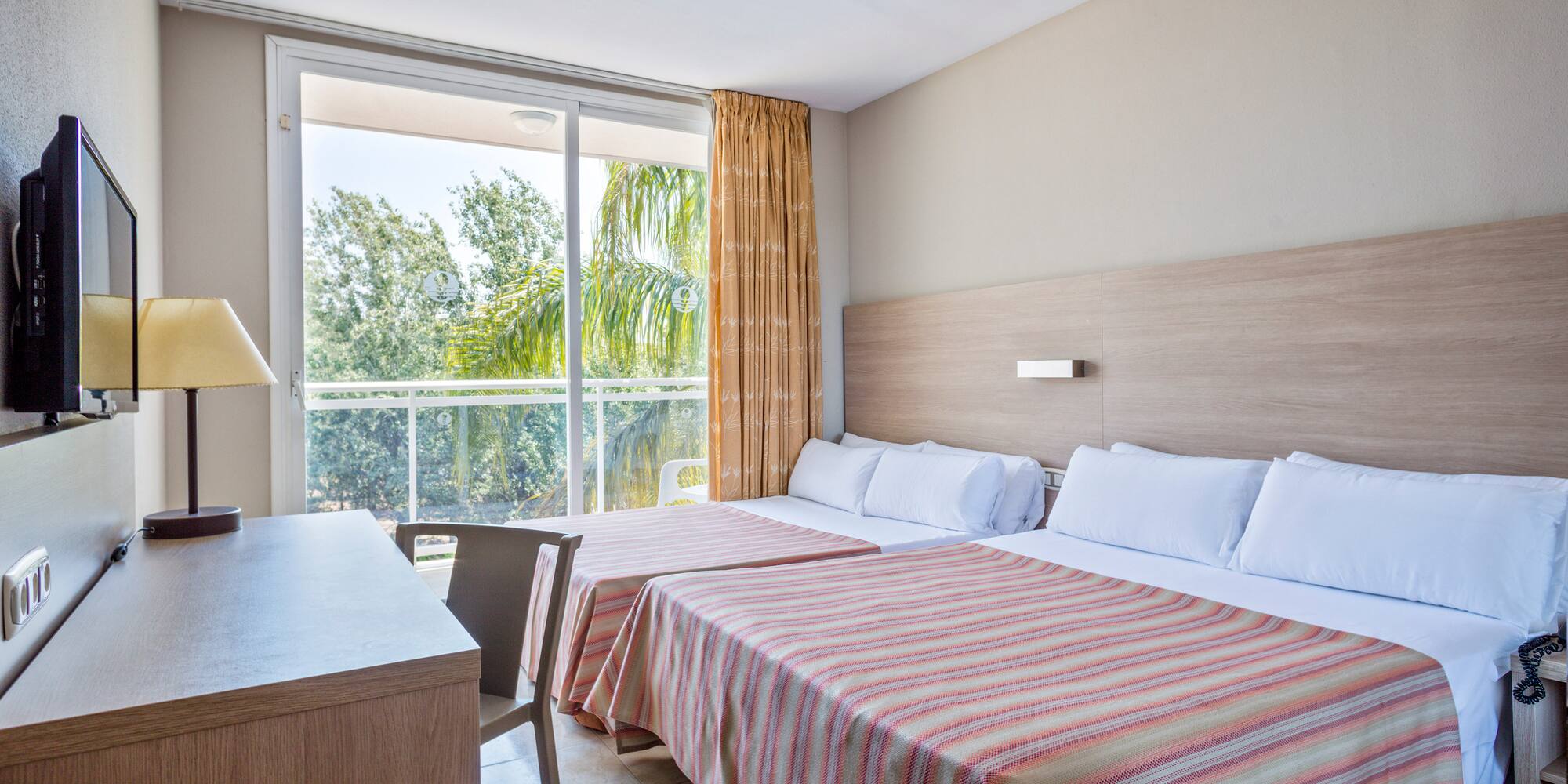 a room with two beds and a desk