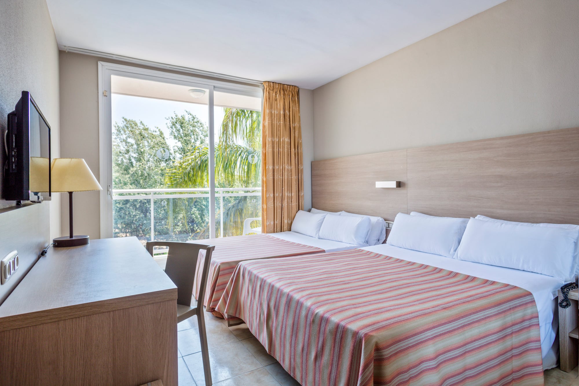 a room with two beds and a desk