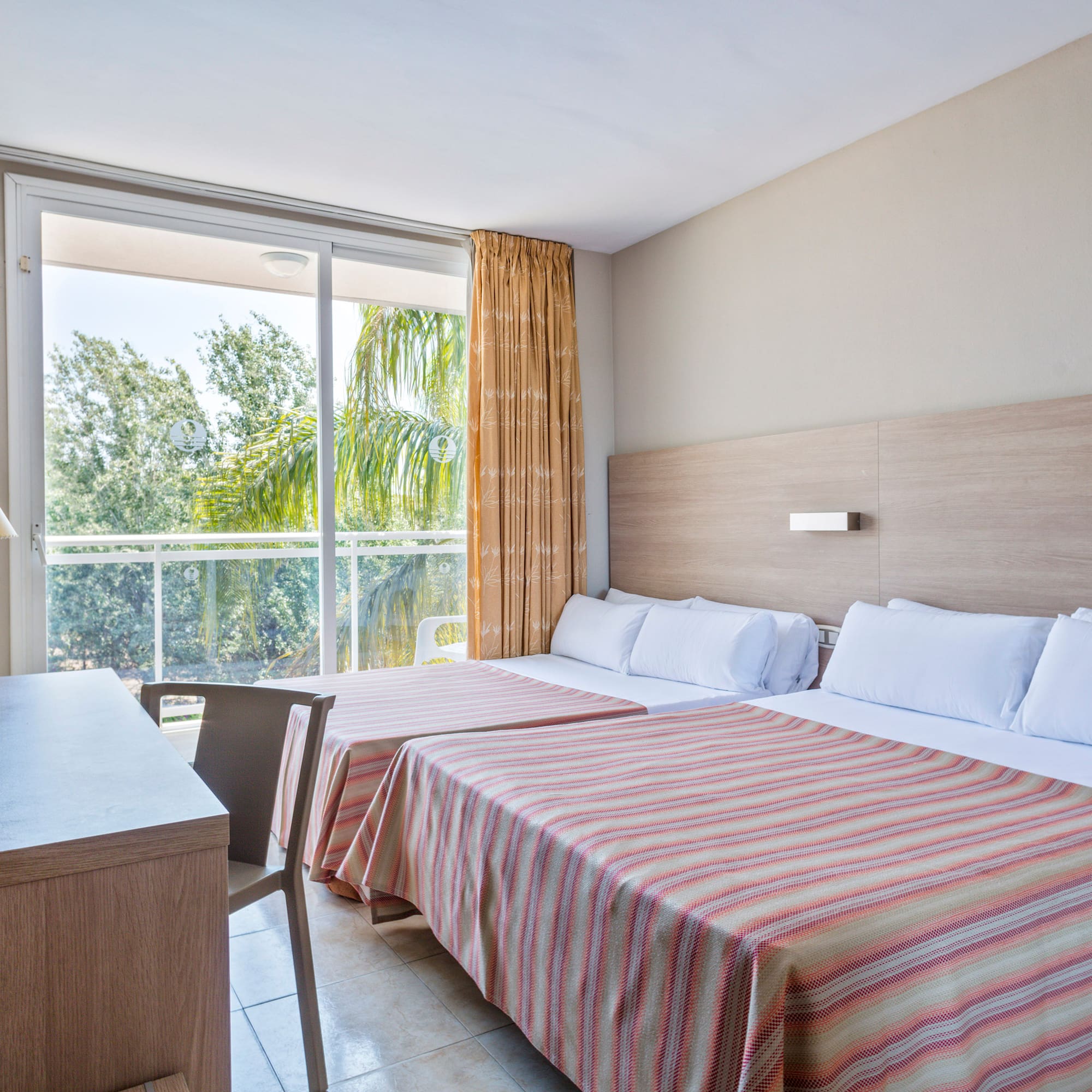 a room with two beds and a desk