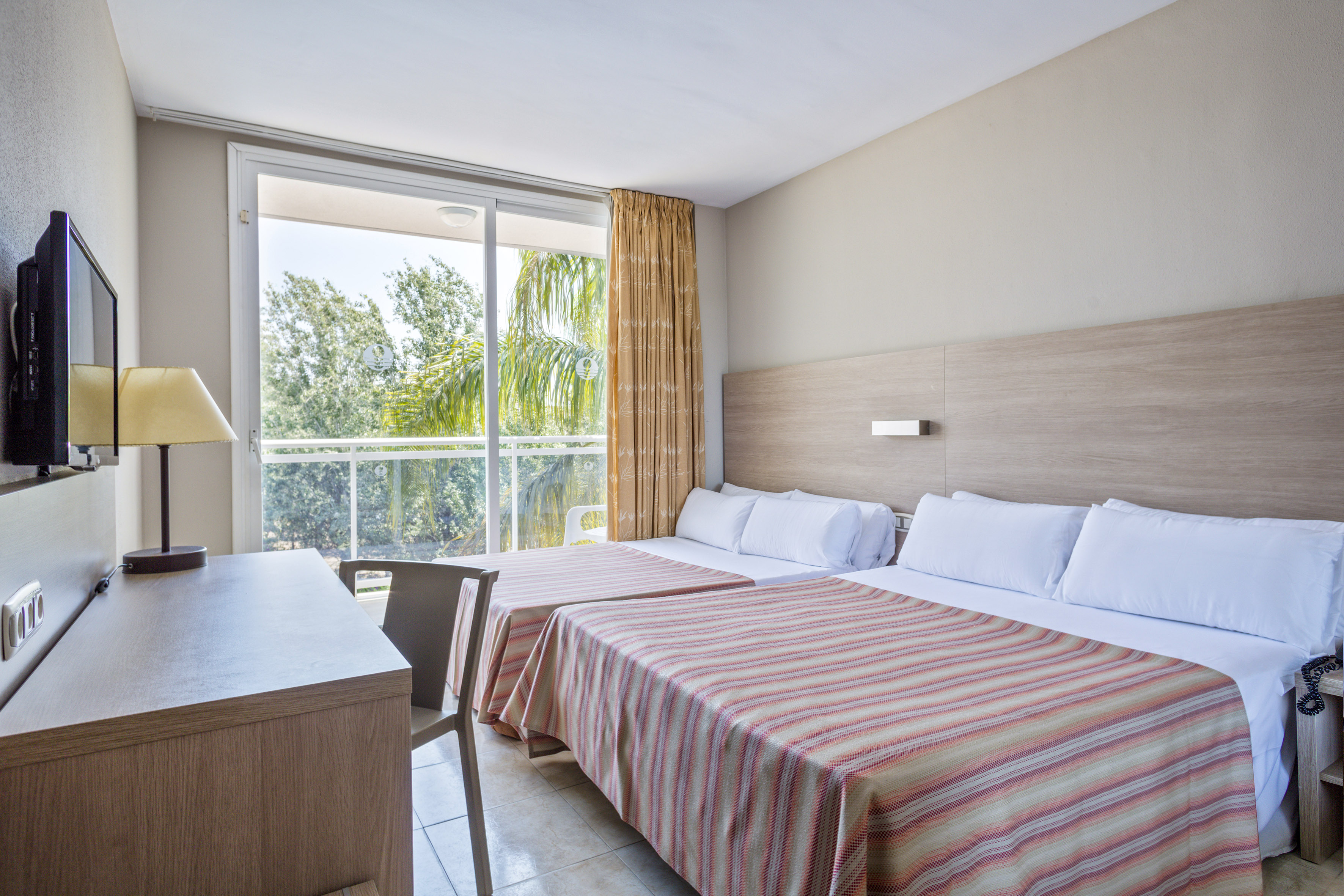 a room with two beds and a desk