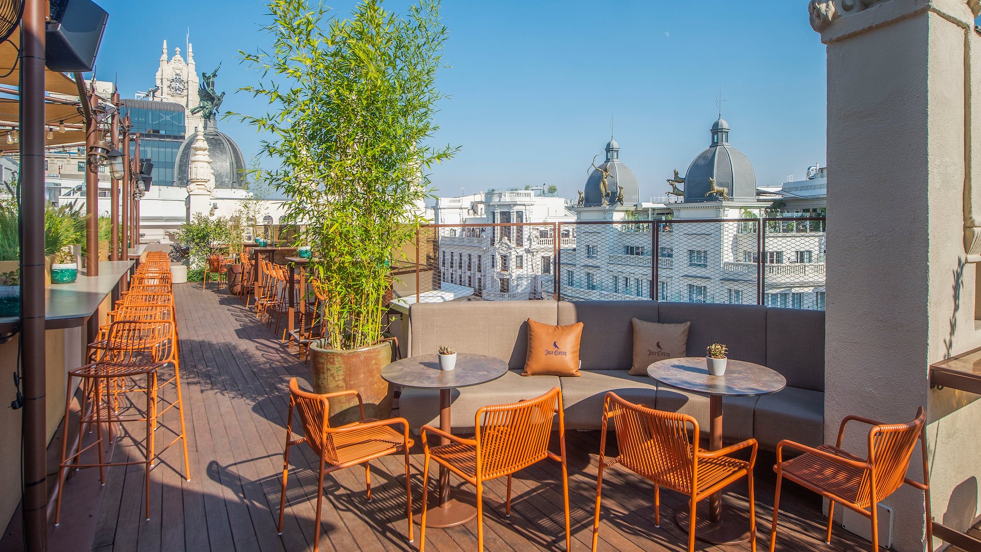 a patio with chairs and tables on a deck