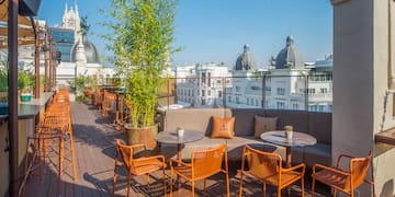 a patio with chairs and tables on a deck