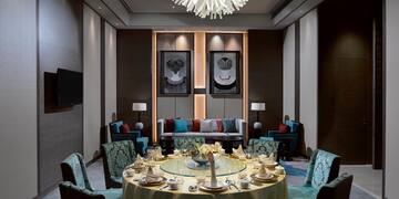 a room with a round table and chairs