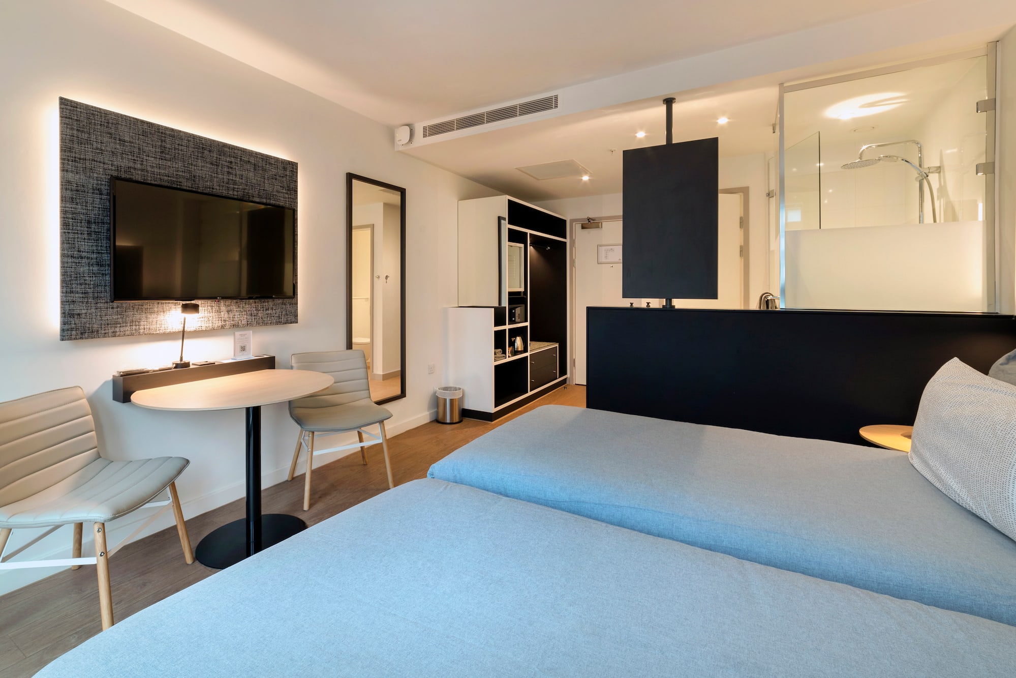 a room with two beds and a tv