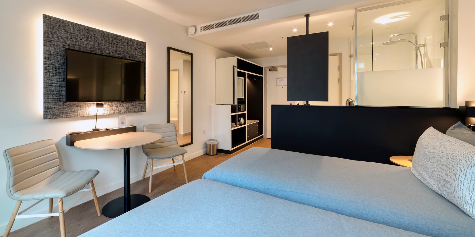 a room with two beds and a tv