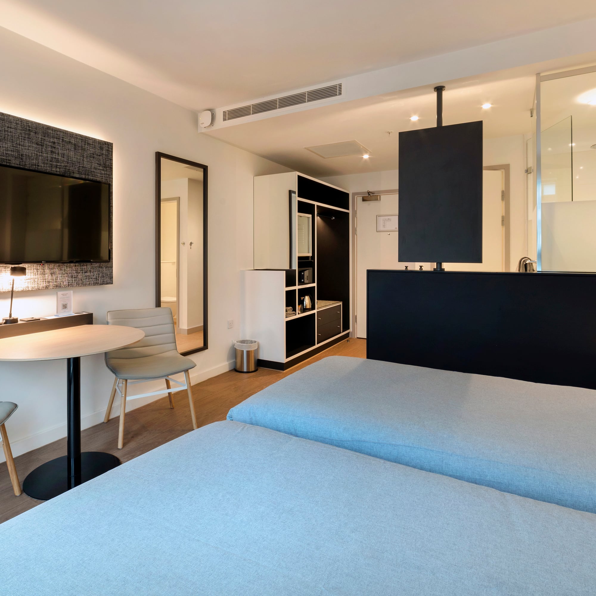 a room with two beds and a tv