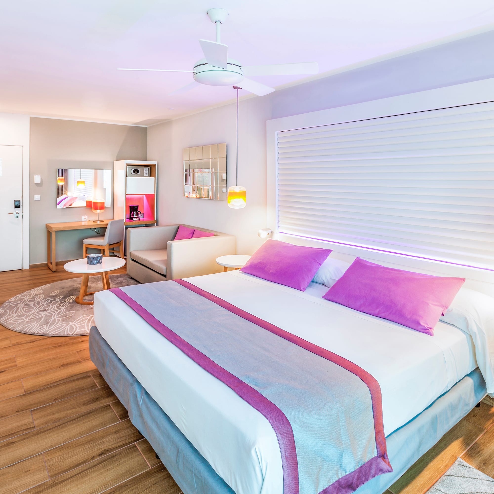 a bedroom with a bed and a ceiling fan