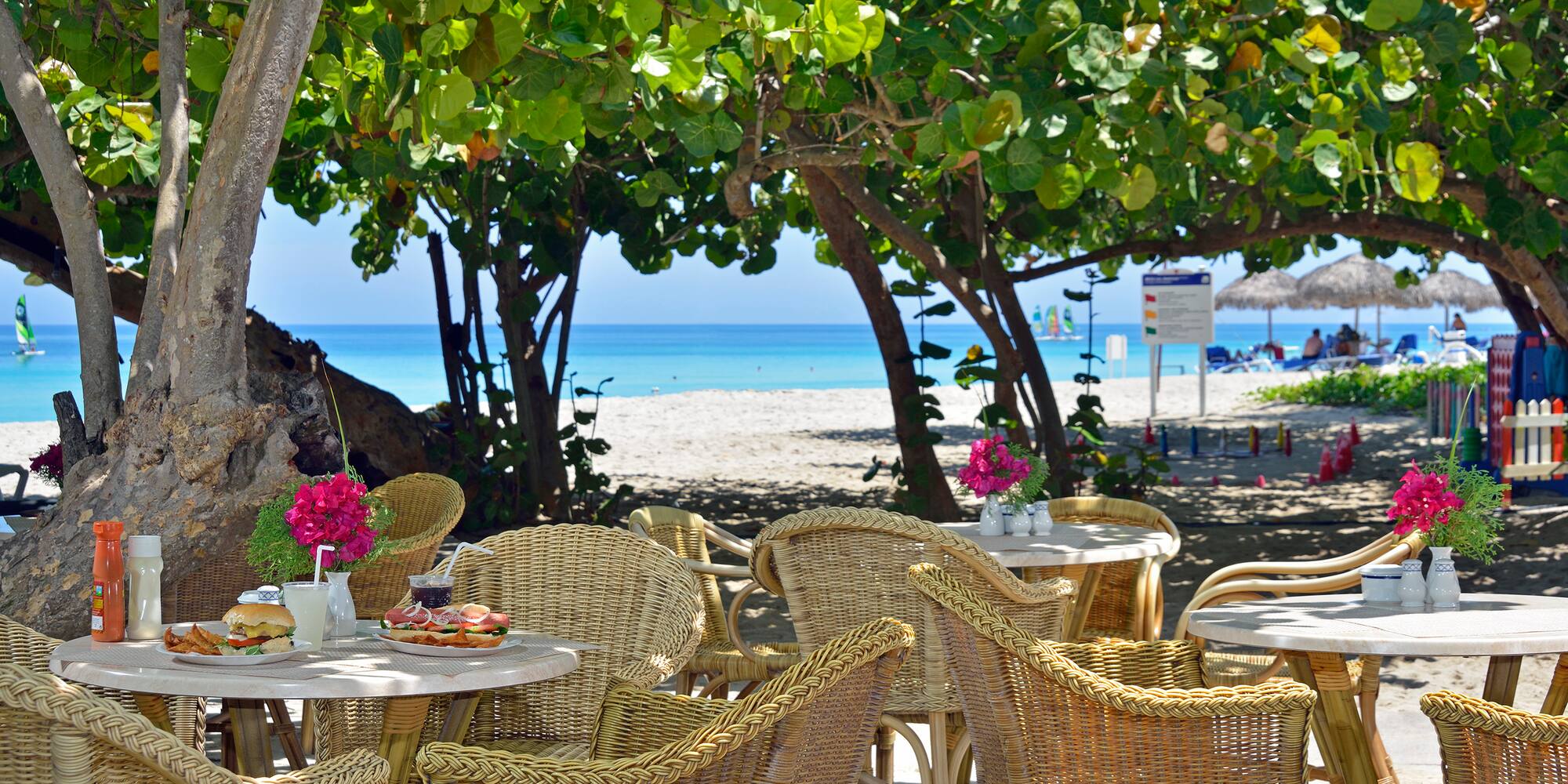 a table and chairs on a beach