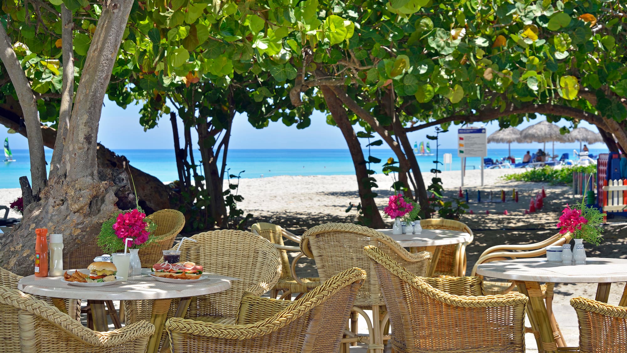 a table and chairs on a beach