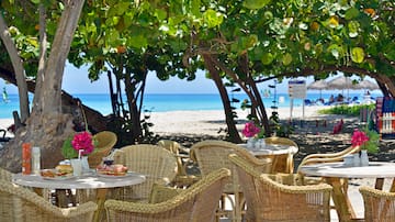 a table and chairs on a beach